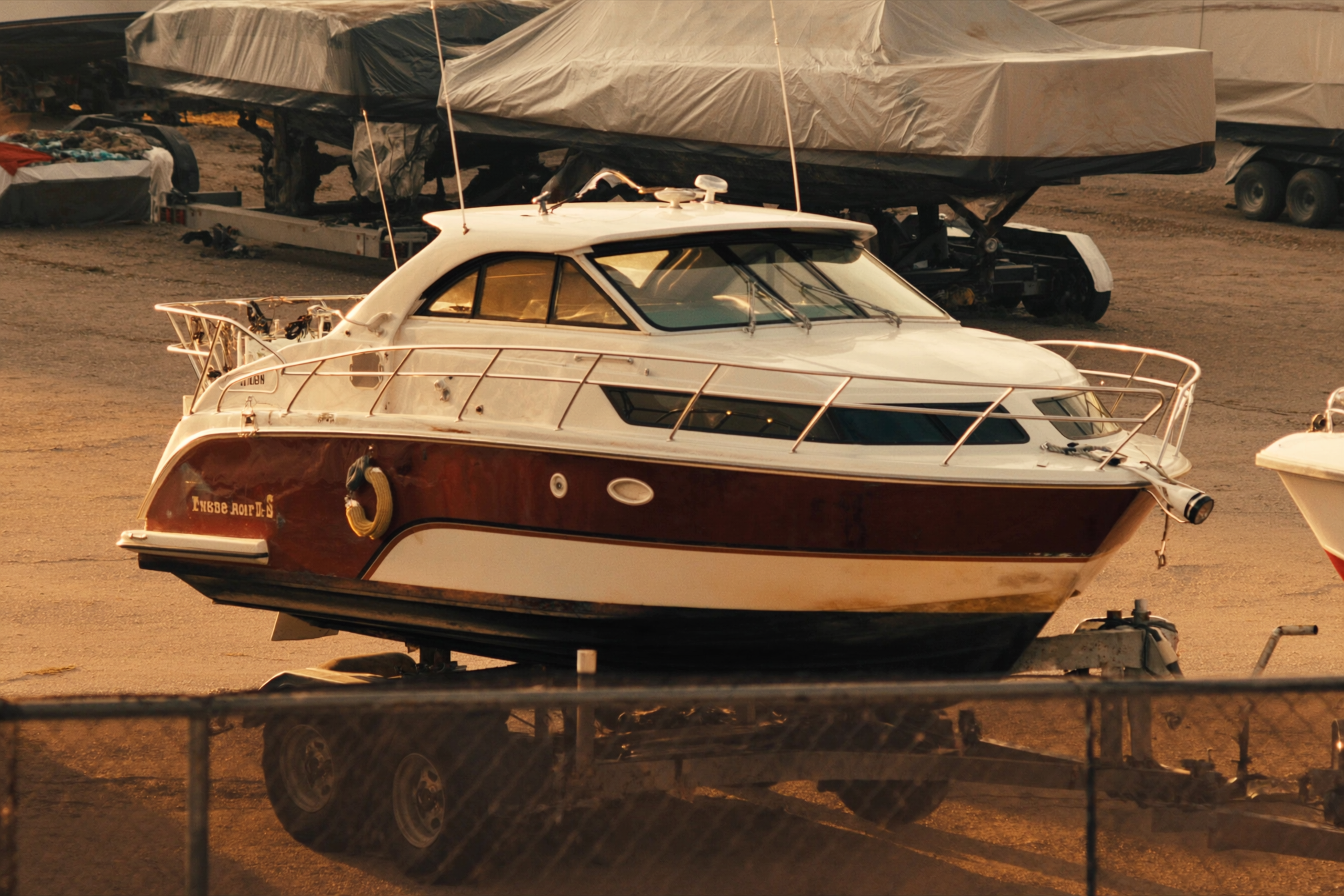 A cabin cruiser boat on its trailer at the JSC storage lot