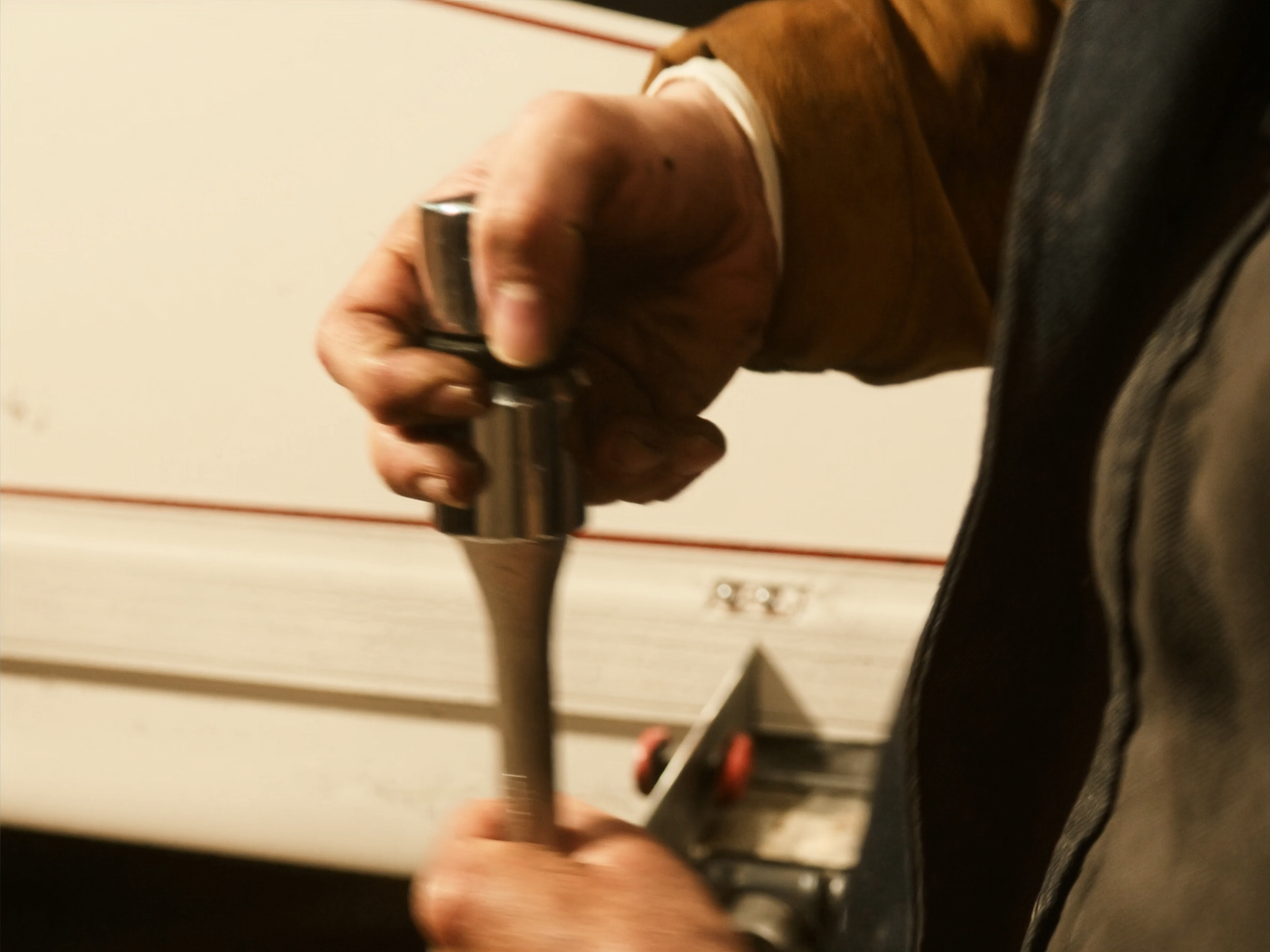 A technician torquing an RV slide-out hardware bolt
